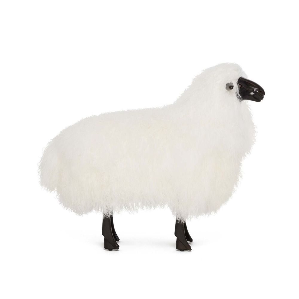 Additional view of Lucie Baby Sheep in white and black, featuring fluffy natural fleece and a freestanding sculptural base.