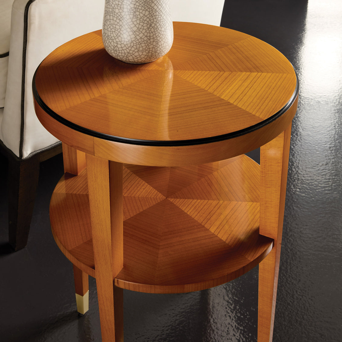 Alternate view of Langford Round Chairside Table in golden amber and rich mahogany.